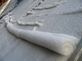 Illustration for article titled These bizarre snow rolls were actually created by the wind